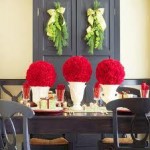 A trio of festive red rose spheres take center stage on this table